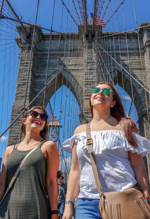 friends walking the brooklyn bridge nyc