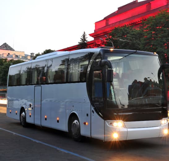 a plain white coach bus on the road